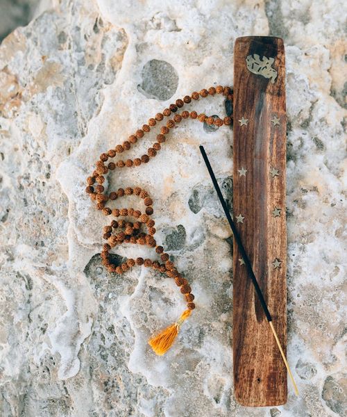 Person meditating peacefully, silhouette against a calm background.